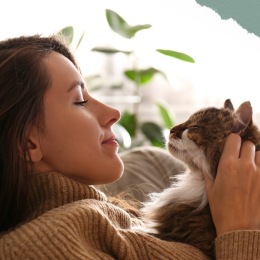 a woman sitting on a sofa with her cat