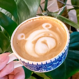 a cup of coffee in a blue and white ceramic cup