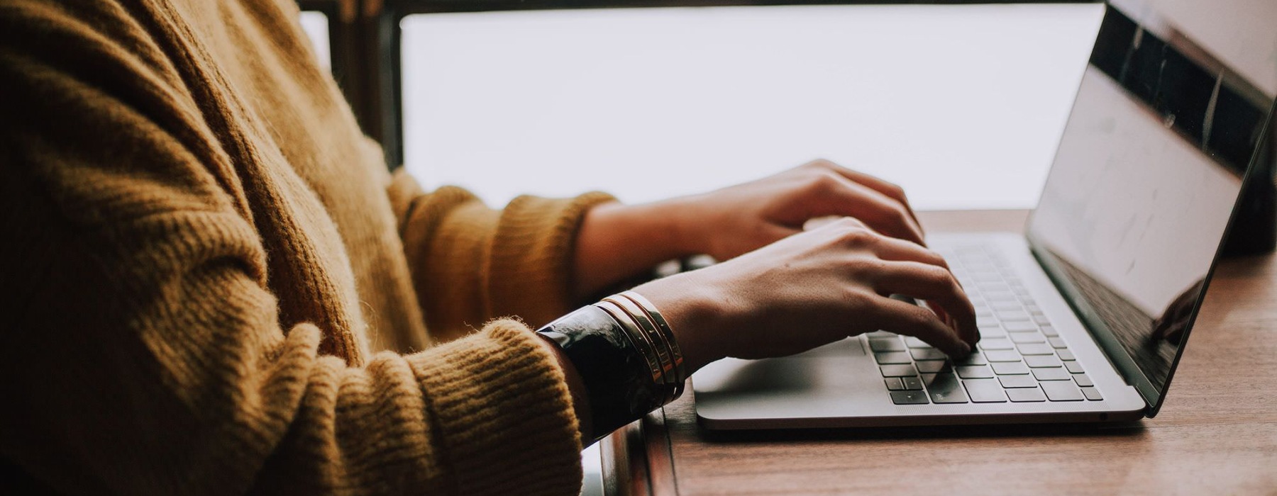 a woman typing on a laptop