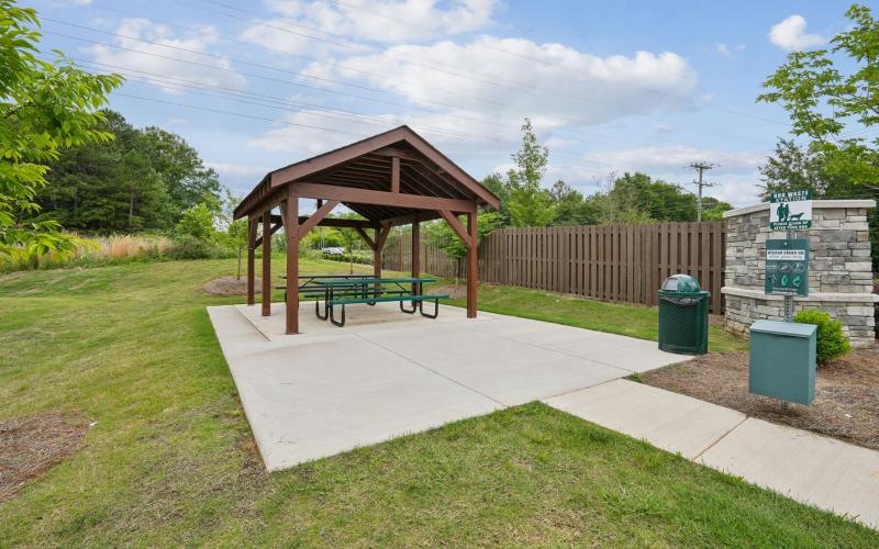 a picnic table and a bench in a park